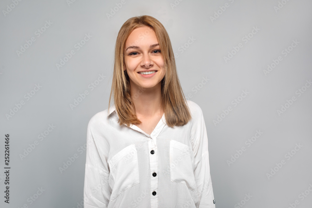 Young woman standing isolated on grey smiling cheerful Young woman standing isolated on grey smiling cheerful