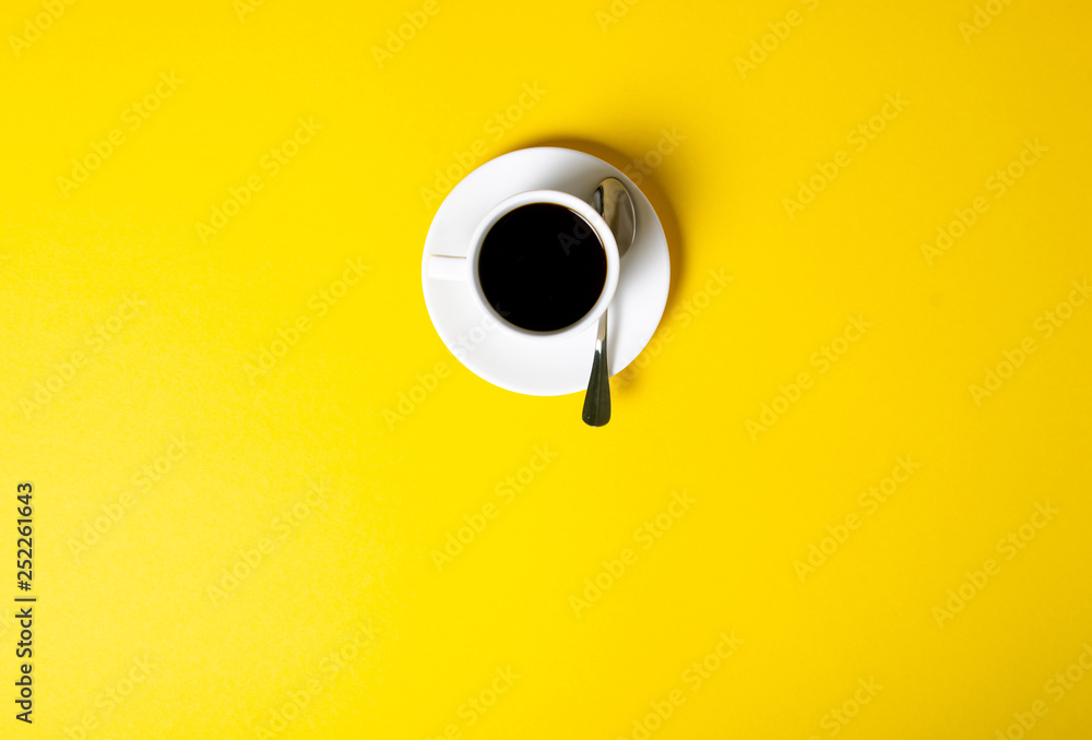 Cup of coffee drink on yellow background, top view Cup of coffee drink on yellow background, top view