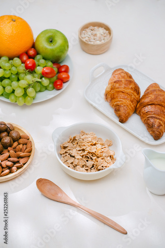 Light healthy Breakfast with oatmeal. Hercules, nuts, fruit, boiled eggs, bread. Tableware. Healthy food.