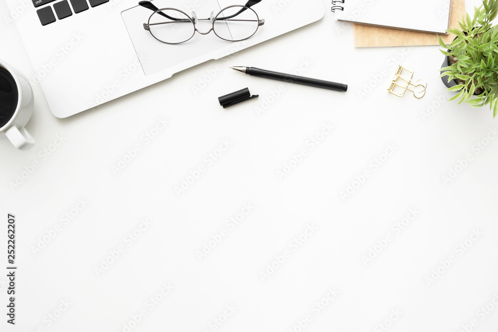 Top view of white office desk table with laptop computer and office supplies. Flay lay image. Top view of white office desk table with laptop computer and office supplies. Flay lay image.