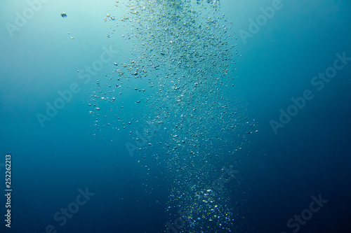 Underwater shot with sunrays and bubbles
