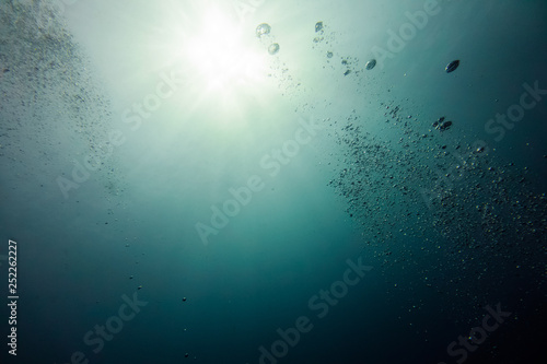 Underwater shot with sunrays and bubbles