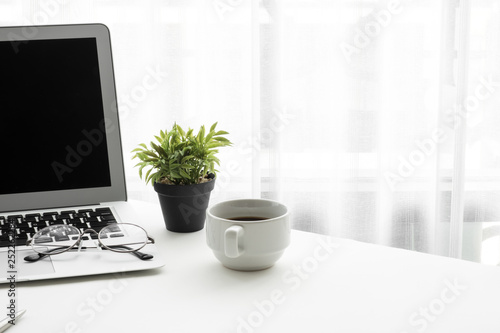 Wallpaper Mural Laptop computer with blank mock up screen is on top of white office desk table with supplies. Torontodigital.ca