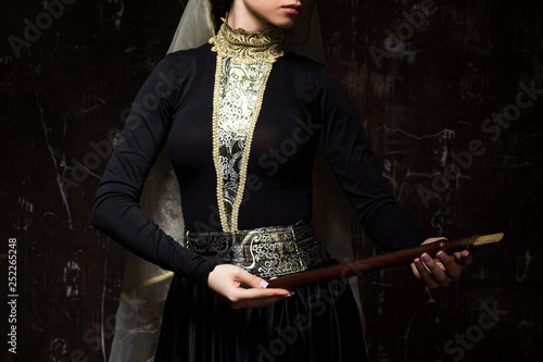 Young woman in armenian national dress with national musical instrument duduk in hands photo