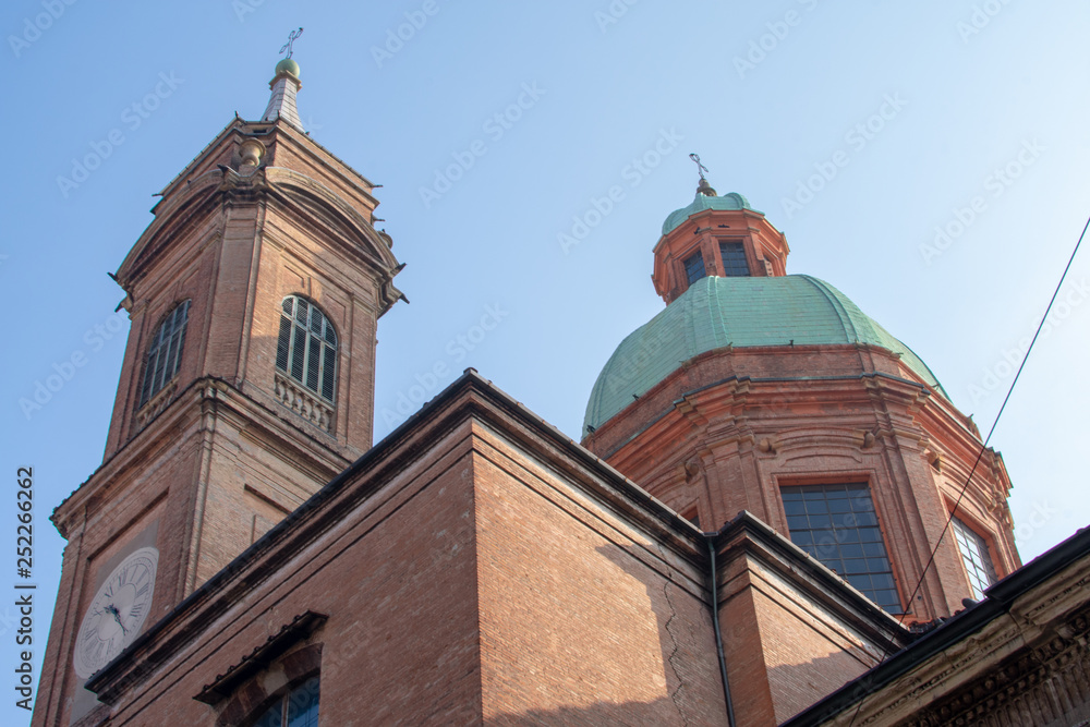 bologna/Italy 20 february 2019 :the clock and church near the two towers in Bologna,