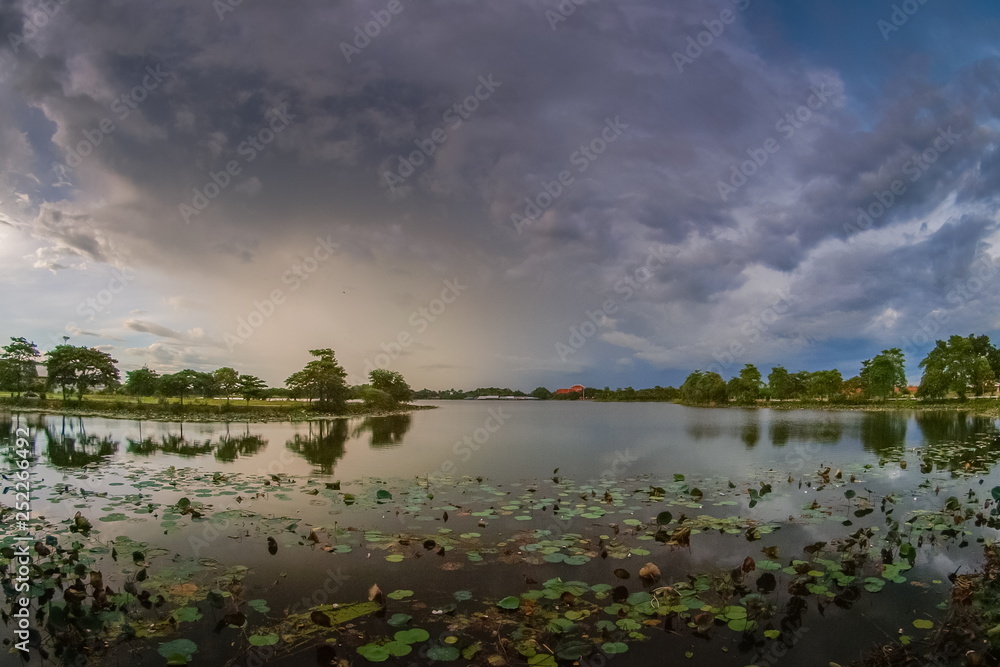 Lake view of dark clouds moving in strong wind with rain storm above the lake, Krajub reservoir in Banpong District, Ratchaburi, Thailand.