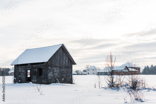 wooden old houses in mountain village in snowy carpathians