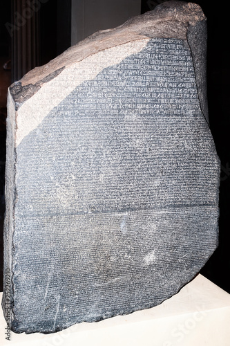 LONDON, ENGLAND - OCTOBER 6, 2014 - The Rosetta Stone - inscription in different languages that helped decipher the ancient Egyptian hieroglyphic script photo
