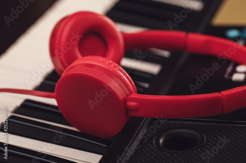 Red headphones over synthesizer keyboard