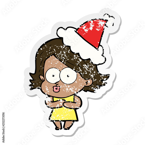 distressed sticker cartoon of a girl pouting wearing santa hat