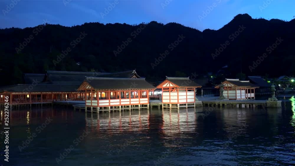 Itsukushima Shrine's halls and pathways on stilts by night. Miyajima, Japan Itsukushima Shrine's halls and pathways on stilts by night. Miyajima, Japan