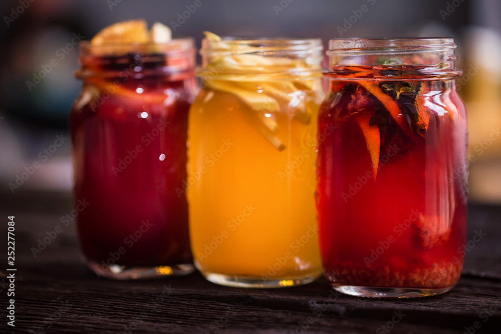 Three glass jars with delicious hot winter beverages close Three glass jars with delicious hot winter beverages close