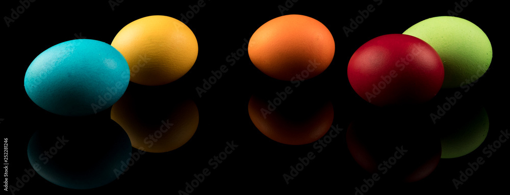 Easter Eggs Banner. Colorful Easter Eggs on black background with reflection. Modern Design.