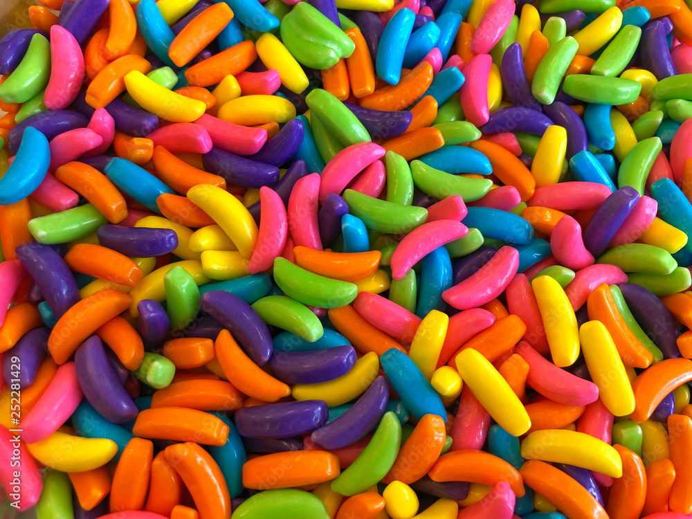 top view flat lay background of Colorful sweet bright candy pieces shaped like bananas, close up background top view flat lay background of Colorful sweet bright candy pieces shaped like bananas, close up background