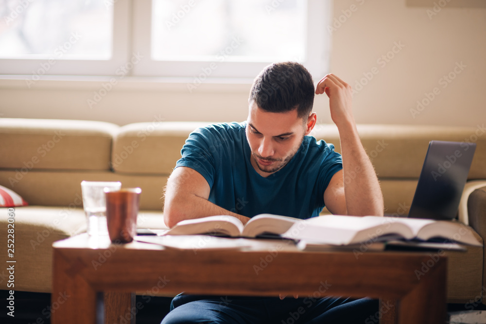 Student study hard for exam in the living room Student study hard for exam in the living room