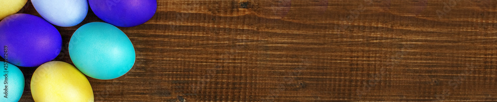 Wooden background with Easter eggs. Concept and happy Easter hol Wooden background with Easter eggs. Concept and happy Easter hol