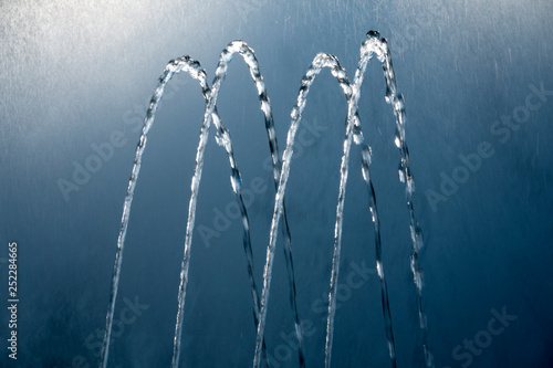 Fotografie Four water jets from a fountain. Abstract image.