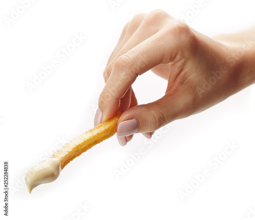 French fries held in fingers isolated on white background