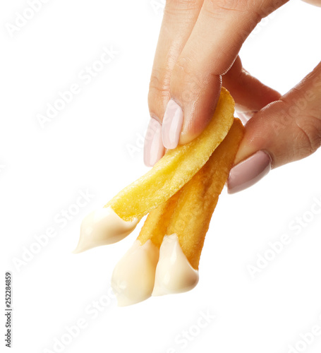 French fries held in fingers isolated on white background