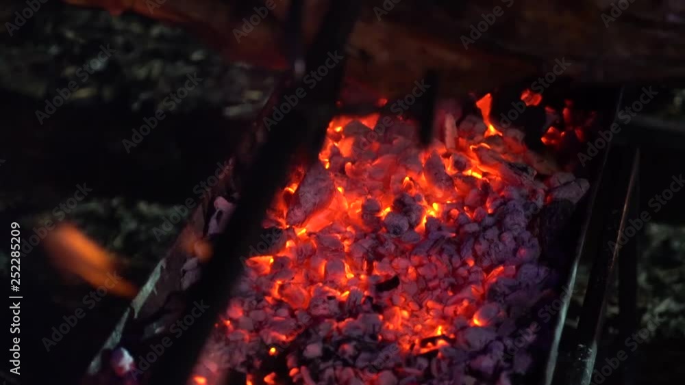 roasting pork carcass on charcoal grill outdoors at night closeup roasting pork carcass on charcoal grill outdoors at night closeup