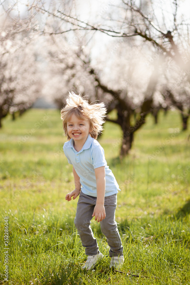 happy children on the street in the spring , flowering gardens happy children on the street in the spring , flowering gardens