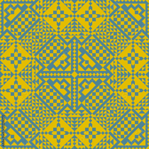 Seamless vector pattern of the elements of yellow and blue. Simple geometric shapes, folded in a repeating pattern for fabrics, wallpapers, materials for lining.