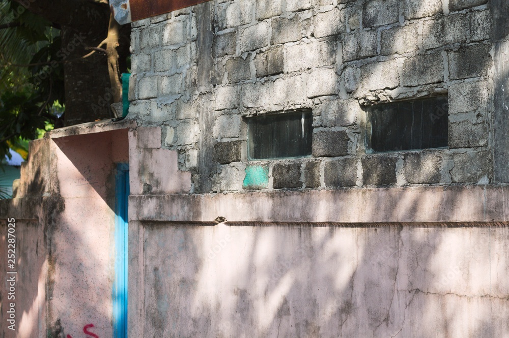 A couple of rectangular windows in a brick wall (Ari Atoll, Maldives)