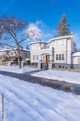 A typical american house in winter. Snow covered.