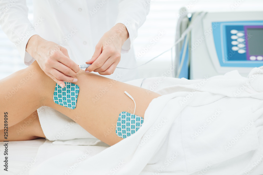 Myostimulation on the legs and hips of a slim fit woman in beauty salon. Non surgical body sculpting. anti-cellulite and body slimming therapy in cosmetological clinic, close up. Myostimulation on the legs and hips of a slim fit woman in beauty salon. Non surgical body sculpting. anti-cellulite and body slimming therapy in cosmetological clinic, close up.