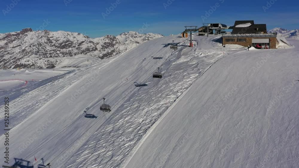 Aerial view of Alps in winter, ski lift on ski slopes, hills covered with snow - Alps mountains from above, ski resort Livigno, Italy, Europe Aerial view of Alps in winter, ski lift on ski slopes, hills covered with snow - Alps mountains from above, ski resort Livigno, Italy, Europe