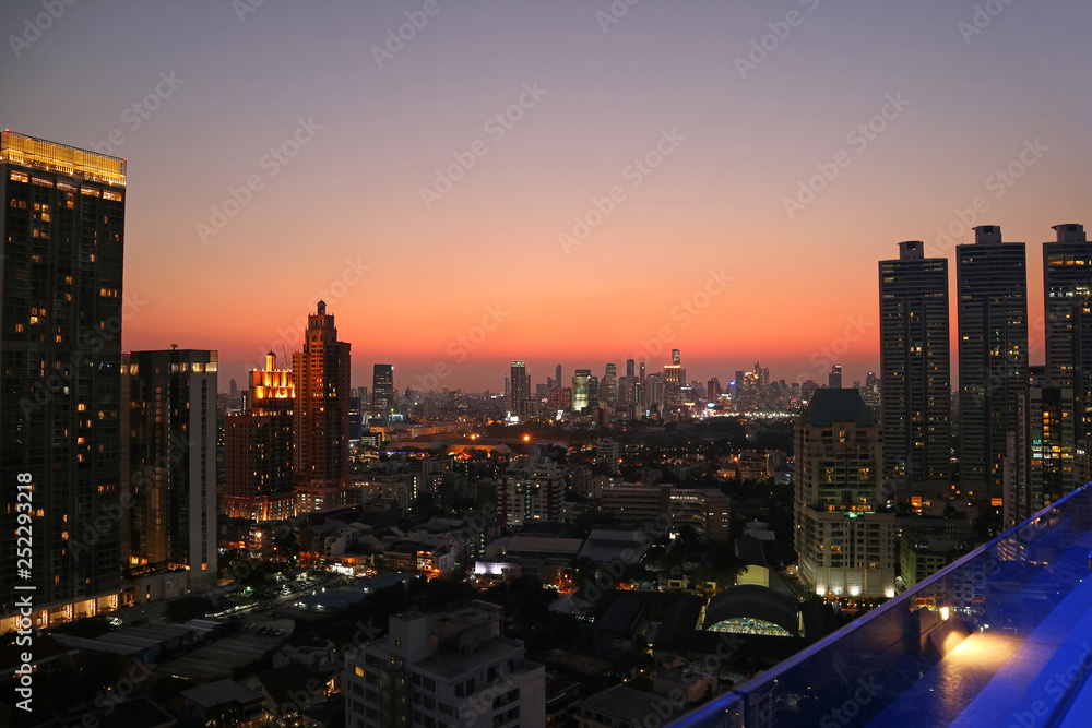 Stunning panoramic view of Bangkok downtown with vibrant color sunset sky in the backdrop