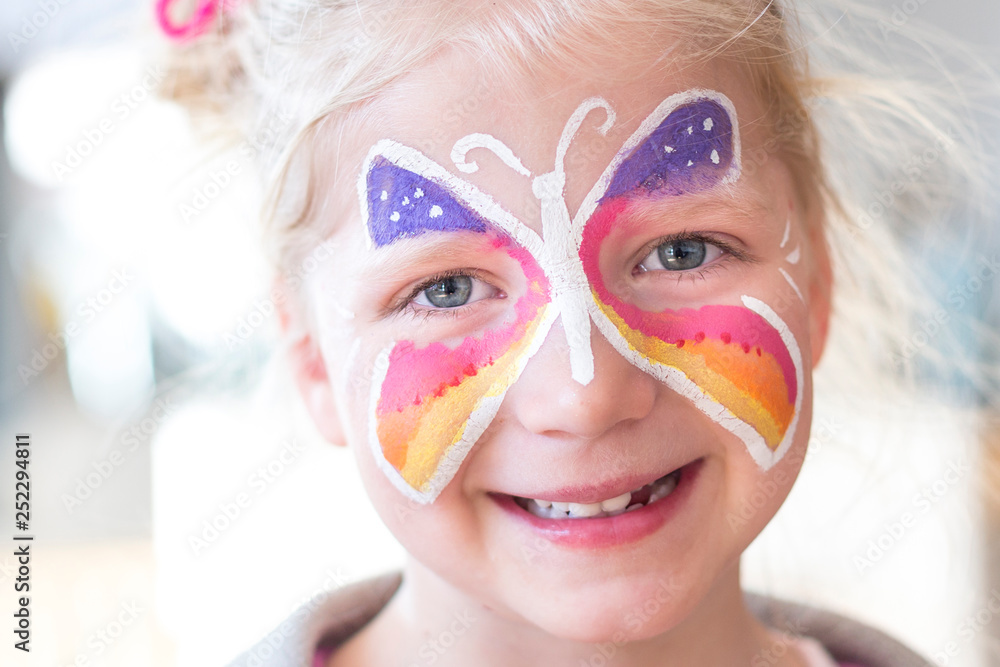 Portrait of blonde girl smiling with painted face Portrait of blonde girl smiling with painted face