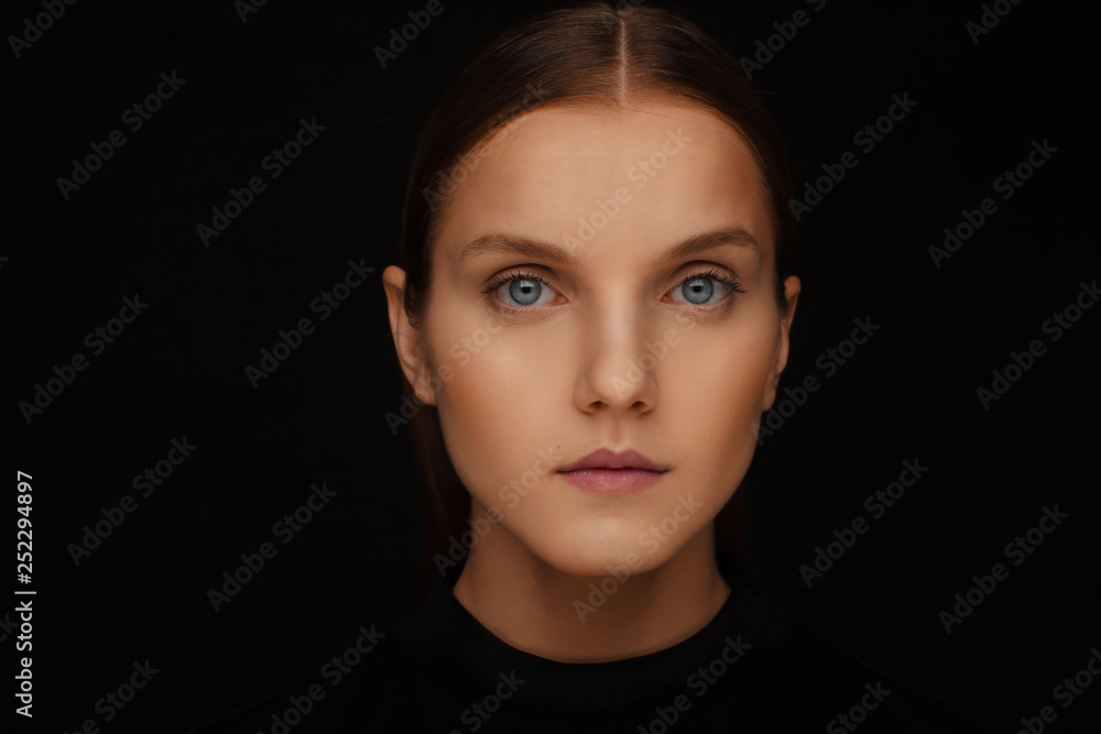 Close-up portrait of a beautiful model with clean makeup and collected hair, photographed in a photo studio Close-up portrait of a beautiful model with clean makeup and collected hair, photographed in a photo studio
