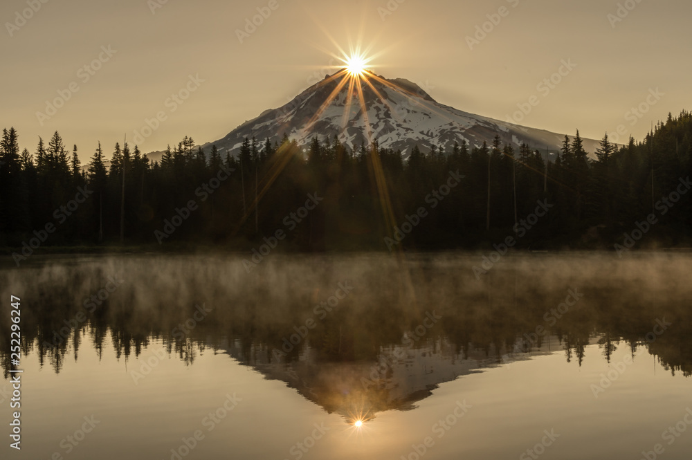 Sunrise over Mt Hood, Oregon's tallest mountain at 11,249 feet (3,429 meters) with Burnt Lake in the foreground.