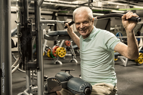 Elderly man working out at the gym studio