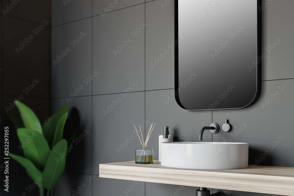 Fototapeta premium Side view of gray tile bathroom with sink