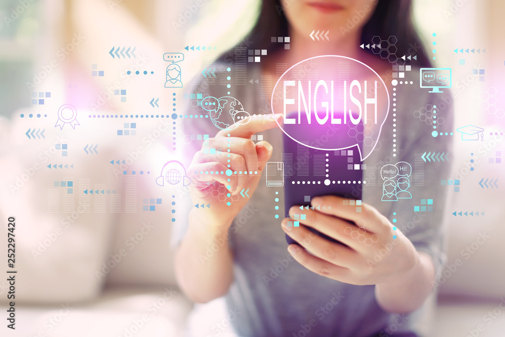 © Tierney - English with woman using her smartphone in a living room © Tierney - English with woman using her smartphone in a living room