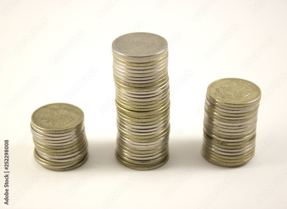three stacks of coins on a white background, rubles three stacks of coins on a white background, rubles