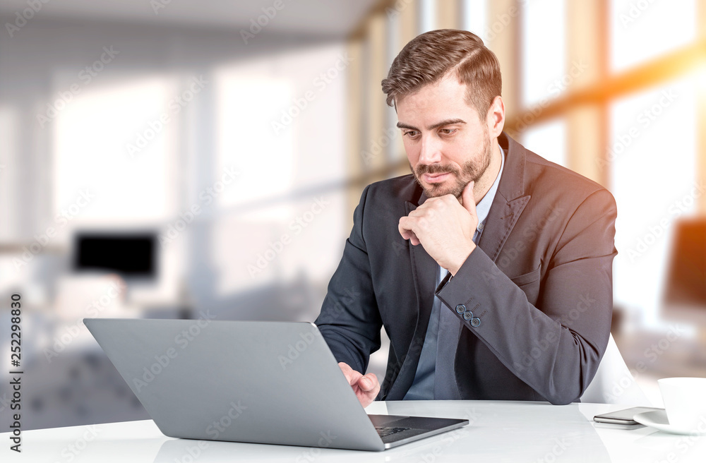 Businessman working with laptop in office Businessman working with laptop in office