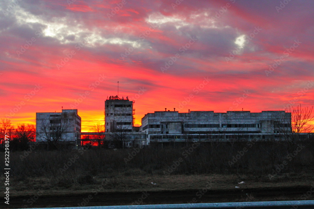 amazing sunset over an abandoned factory outside the city
