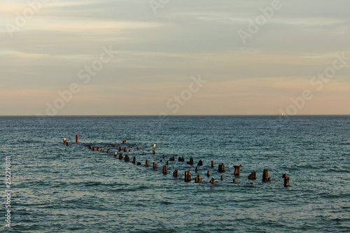 the ruins of the old pier rising out of the water © JerryMouse