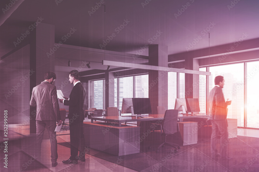 People in gray panoramic office with columns People in gray panoramic office with columns