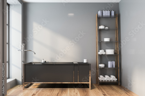 Gray bathroom interior, tub and shelves