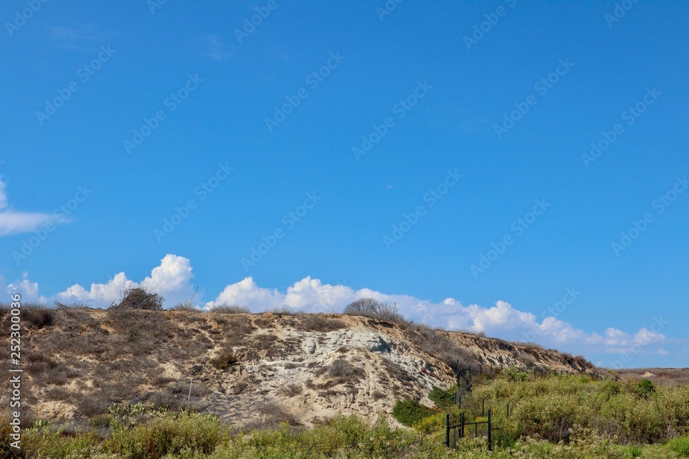 clouds on blue sky over cliff