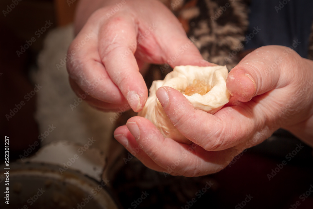 Cooking pies with cabbage in the home of an elderly woman Cooking pies with cabbage in the home of an elderly woman