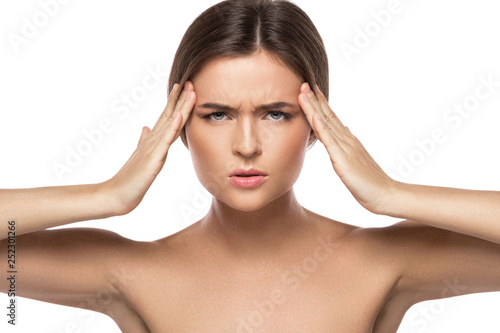 Woman with a headache on white background