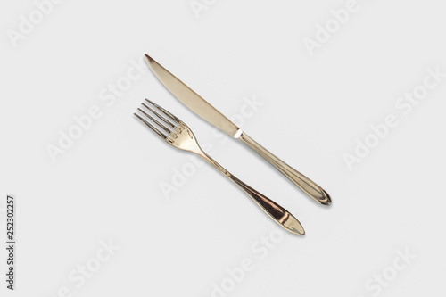 Fork and knife mockup. Stainless steel, gold kitchenware, flatware. Isolated on a white background ready for your design.