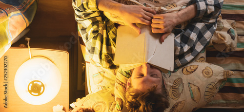 student fell asleep while reading book in bed b