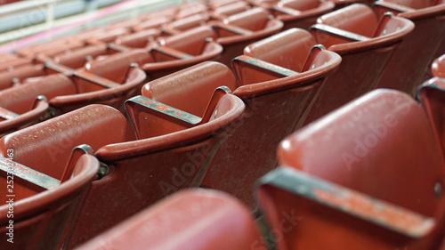 Empty stadium with red folding metal seats
