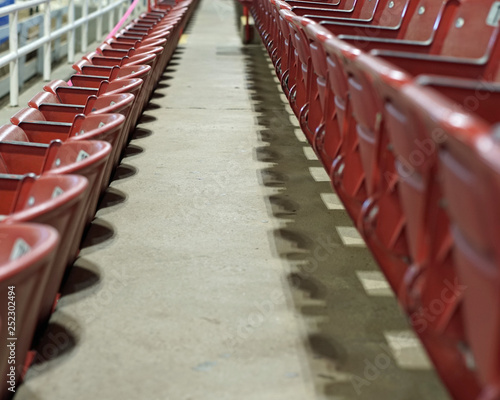 Empty stadium with red folding metal seats © martyweil